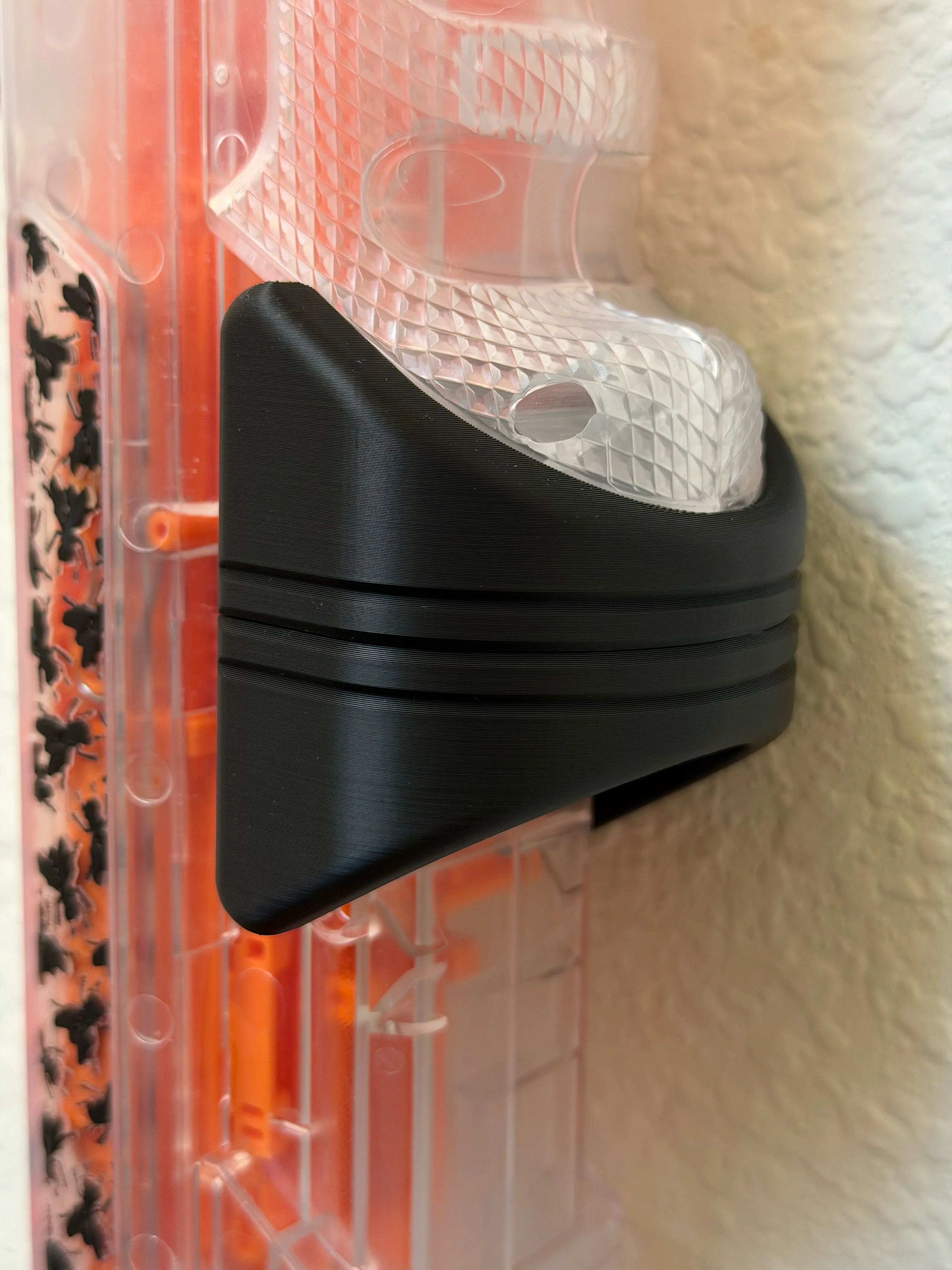 Close-up of the wall mount cradling the Bug-A-Salt V3 hand-cocking section